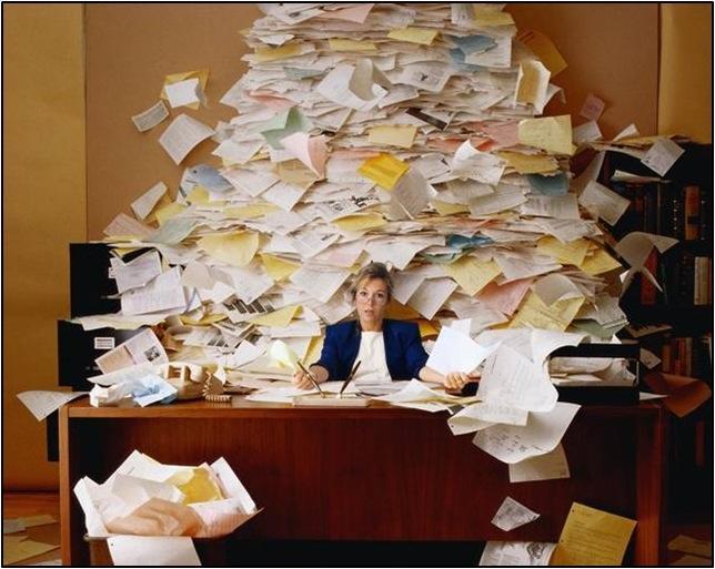overwhelmed woman with sticky notes at desk showing signs of people pleasing and burnout set healthy boundaries